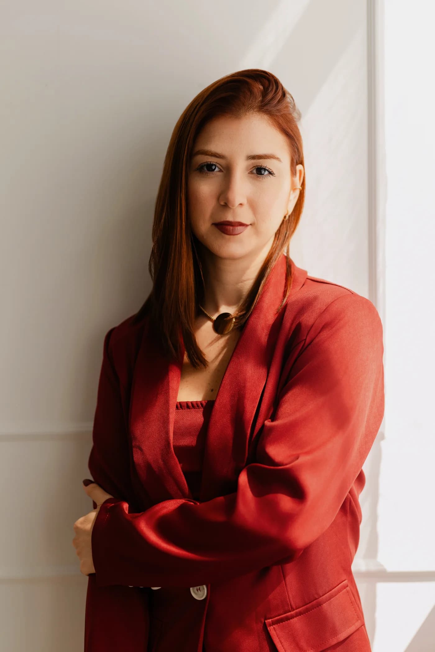 Fernanda Smanio, contadora, de blazer marsala e braços cruzados